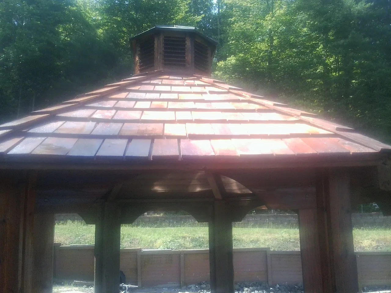 New cedar shake roof and cupola on a lakeside gazebo in Paris